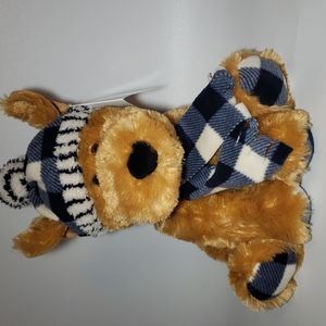 Teddy bear, blanket soft, checkered hat and scarf .